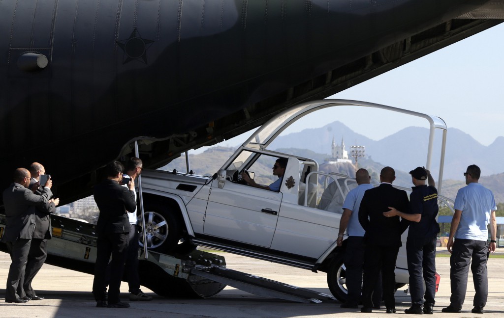 The popemobile is off loaded at Galeao air base in Rio de Janeiro July 15 ahead of the visit of Pope Francis. He will travel to Brazil on his first international trip as pope to greet hundreds of thousand of young people for the international gathering of World Youth Day. PHOTO: CNS/Ricardo Mores, Reuters