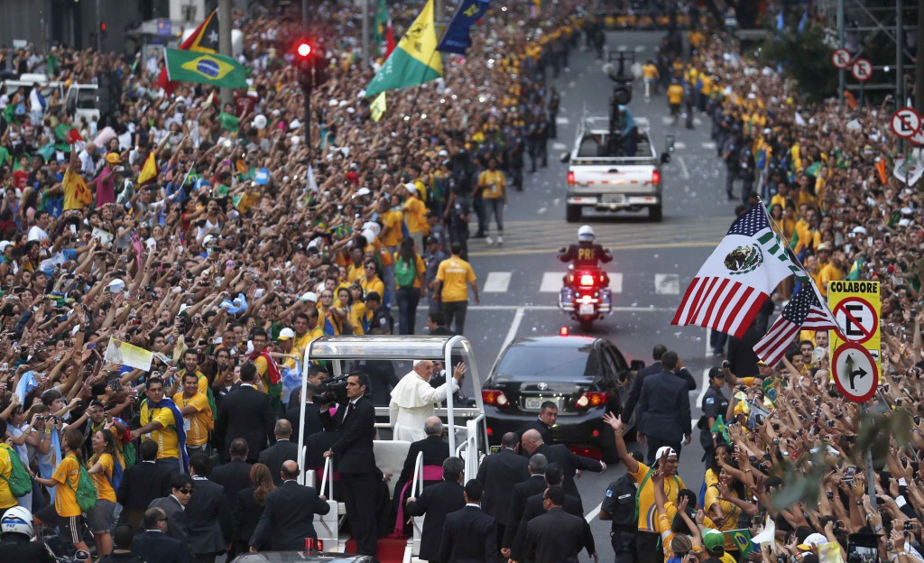 Pope Francis waves from his popemobile after arriving in Rio de Janeiro July 22. The pope is making his first trip outside Italy to attend World Youth Day, the international Catholic youth gathering. PHOTO: CNS/Stefano Rellandini, Reuters