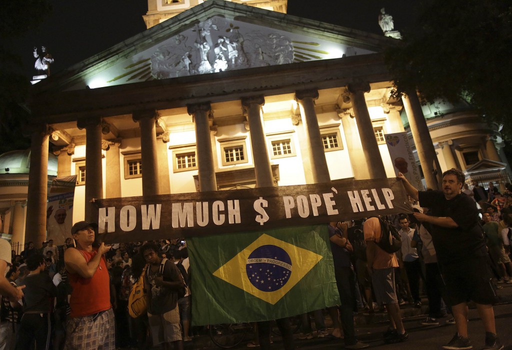 Protesters demonstrate near Guanabara Palace in Rio de Janeiro, where Pope Francis met Brazilian politicians July 22. Demonstrators are continuing their anti-government protests, which began in June amid growing economic and social dissatisfaction in Brazil. PHOTO: CNS/Ueslei Marcelino, Reuters
