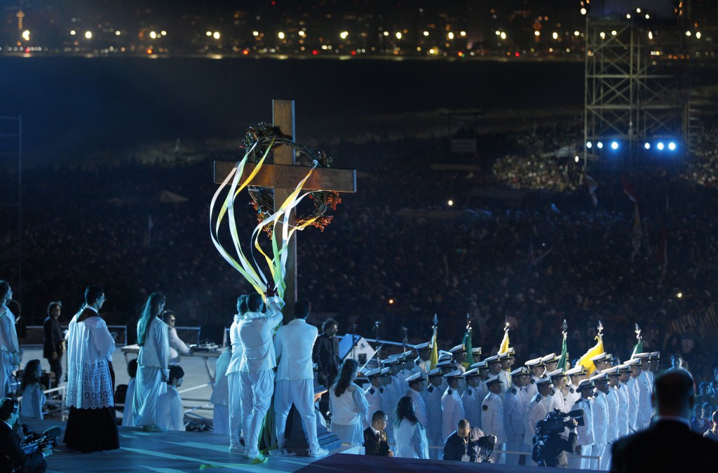 A cross is carried onstage during the Way of the Cross at World Youth Day in Rio de Janeiro July 26. In his reflection during the service, the pope told young people that in every encounter with ChristÕs cross, they can draw strength from him and they can leave the heaviest part of their burden with him. PHOTO: CNS/Paul Haring