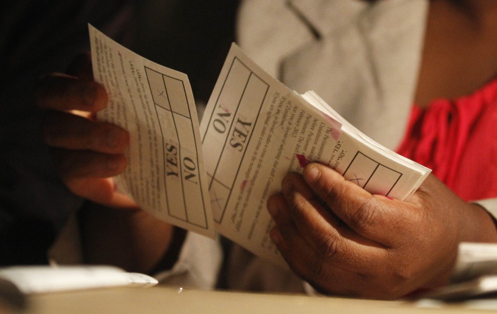 A Zimbabwean election official in Harare counts ballot papers on March 16 after the close of voting on a constitutional referendum. PHOTO: CNS/Philimon Bulawayo, Reuters