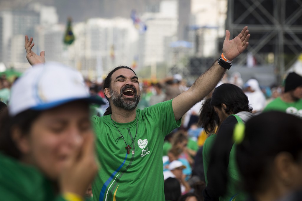 A pilgrim sings on July 28 during the World Youth Day closing Mass on Copacabana beach in Rio de Janeiro. PHOTO: CNS/Tyler Orsburn