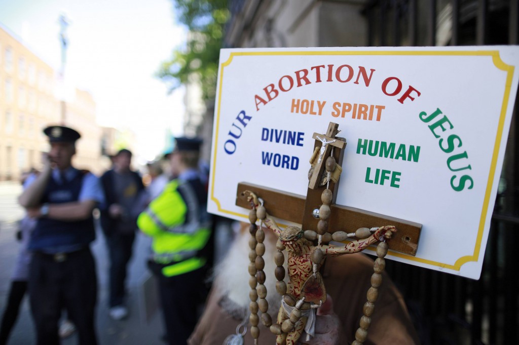 A sign with a crucifix and rosary are seen during a pro-life demonstration July 10 outside the Irish Parliament in Dublin ahead of a vote to allow limited abortion in Ireland. PHOTO: CNS/Cathal McNaughton, Reuters