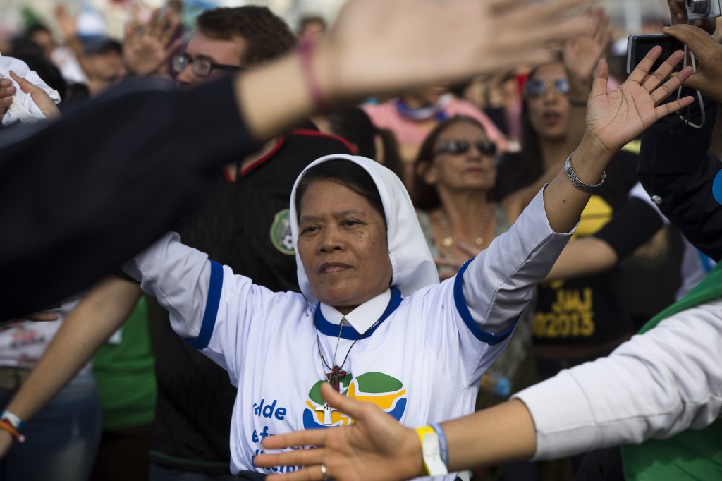 Pilgrims sing during the World Youth Day closing Mass on Copacabana beach in Rio de Janeiro July 28. During the service, Pope Francis commissioned an estimated 3 million people in attendance to become missionaries without borders. PHOTO: CNS/Tyler Orsburn