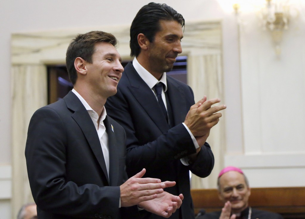 Two international soccer stars, Argentina's Lionel Messi and Italy's Gianluigi Buffon, applaud after a news conference at the Vatican Aug. 13. The two helped launch a Vatican initiative to bring together schools from around the world in projects to promote understanding and solidarity. PHOTO: CNS/Stefano Rellandini, Reuters