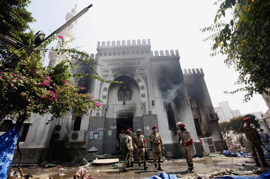 Military police stand outside the burned Rabaa Adawiya mosque Aug. 15, the morning after the clearing of a protest which was held around the mosque in Cairo. Egyptian authorities significantly raised the death toll from nationwide clashes between police and supporters of the ousted Islamist President Mohammed Morsi, saying more than 500 people died. PHOTO: CNS/Mohamed Abd El Ghany, Reuters