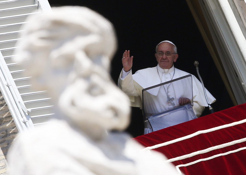 Pope Francis leads the Angelus on Aug. 18 from a window in the Apostolic Palace at the Vatican. PHOTO: CNS/Alessandro Bianchi, Reuters