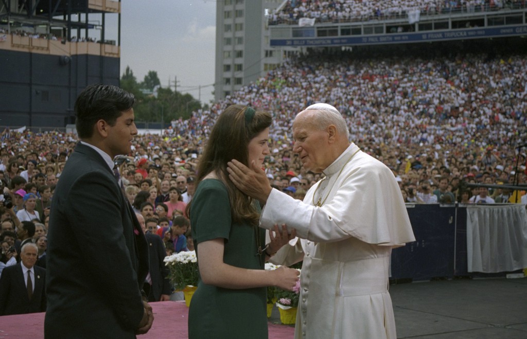 ope John Paul II greets young people at Denver's Mile High Stadium during World Youth Day in 1993. Cardinal Angelo Amato, prefect of the Congregation for Saints' Causes, told Vatican Radio Aug. 20 that only Pope Francis knows for sure the date he will proclaim the two popes saints, although he already implied that it is likely to be in 2014. PHOTO: CNS/Joe Rimkus Jr.