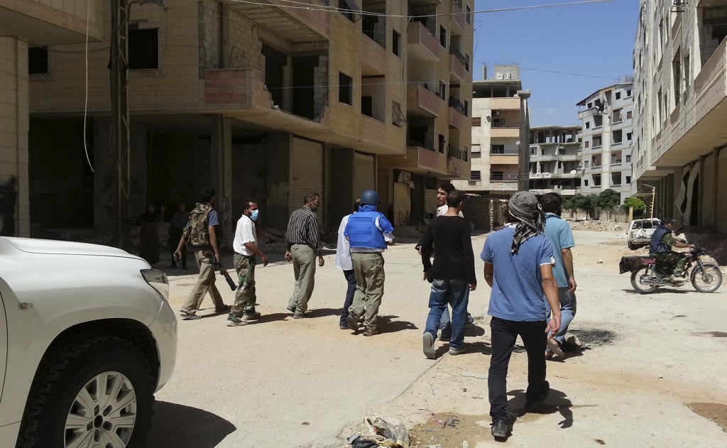 U.N. chemical weapons experts on August 26 inspect one of the sites of an alleged poison gas attack in the Damascus suburb of Mouadamiya. PHOTO: CNS/Abo Alnour Alhaji, Reuters