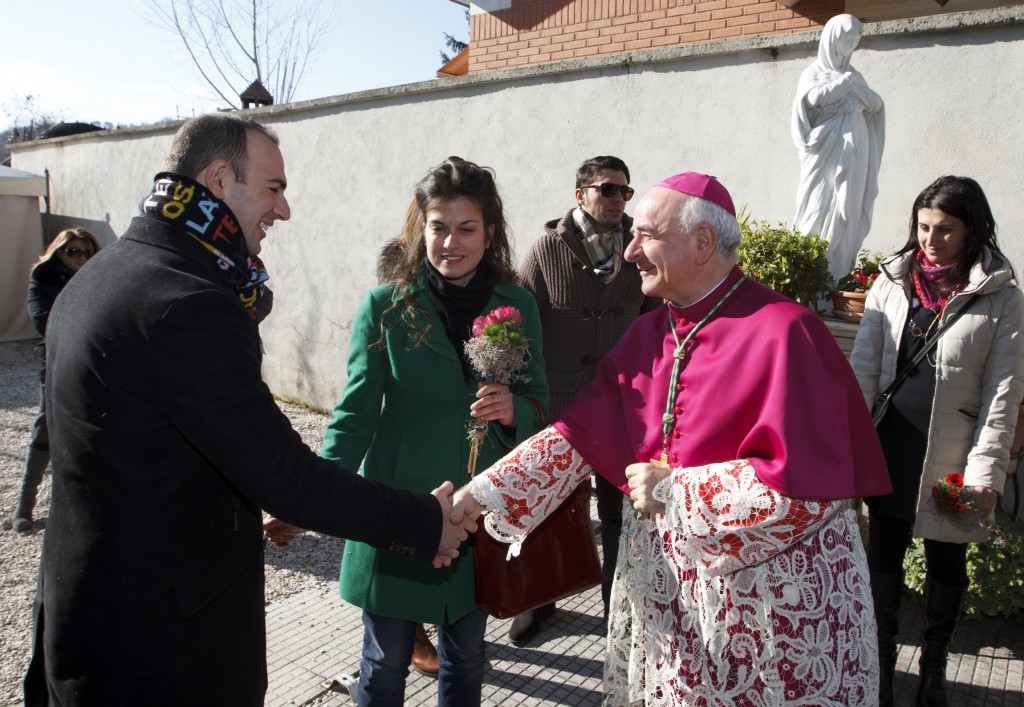 Archbishop Vincenzo Paglia, president of the Pontifical Council for the Family, greets a couple before a special Mass for engaged couples in early February at the Basilica of St. Valentine in Terni, Italy. The international pilgrimage of families Oct. 26-27 is being planned as a celebration and not a protest against any policy or trend, said Archbishop Paglia. PHOTO: CNS/Paul Haring