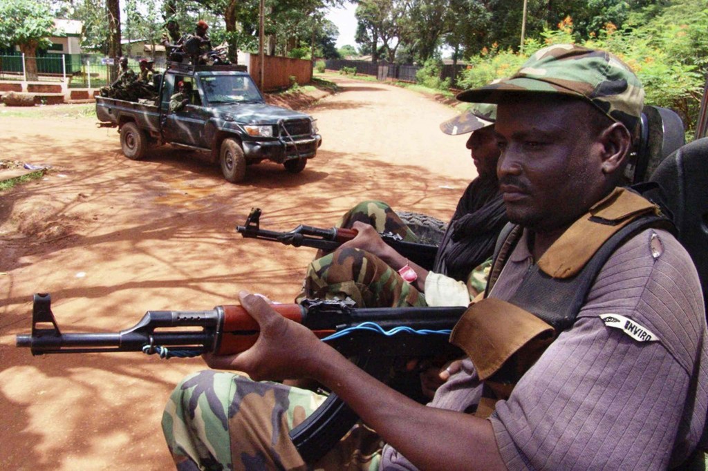 Armed rebel fighters calling themselves Seleka ("Alliance") patrol the streets in pickup trucks to stop looting in Bangui, Central African Republic, March 26. Church leaders in the Central African Republic appealed for international help in restoring order after a wave of attacks on Catholic clergy and churches. PHOTO: CNS/Alain Amontchi, Reuters