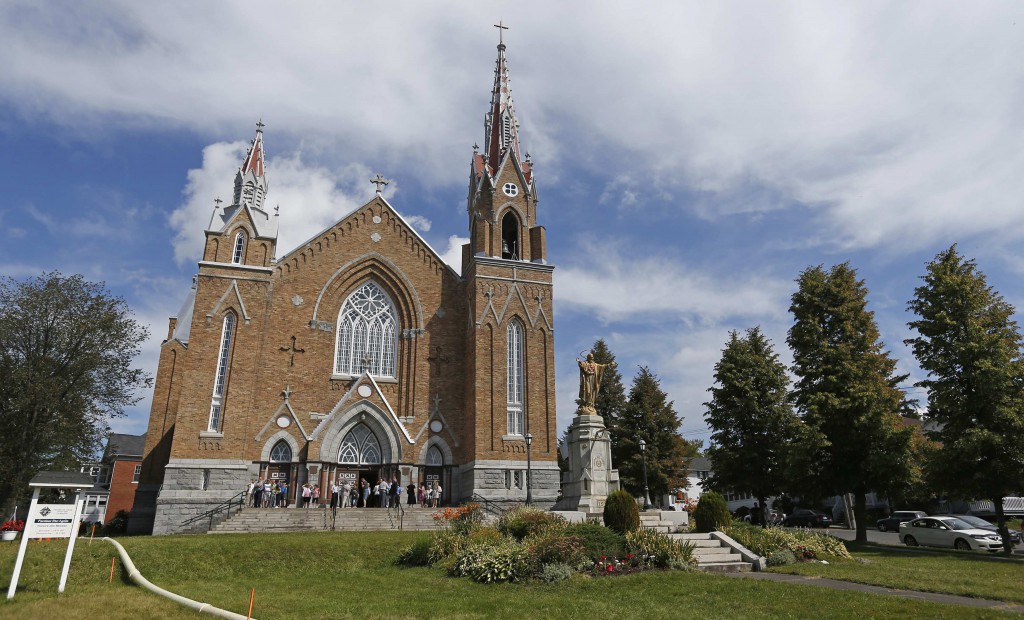 People leave Sainte-Agnes Church on  July 14 in Lac Megantic, Quebec, following Mass. PHOTO: CNS/Mathieu Belanger, Reuters