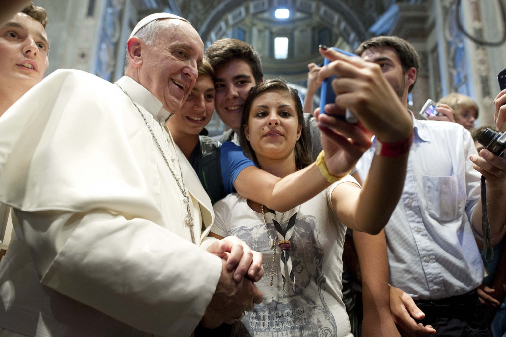 Pope Francis poses with youths during a meeting with young people from the northern Italian diocese of Piacenza-Bobbio in St. Peter's Basilica at the Vatican. PHOTO: CNS/L'Osservatore Romano