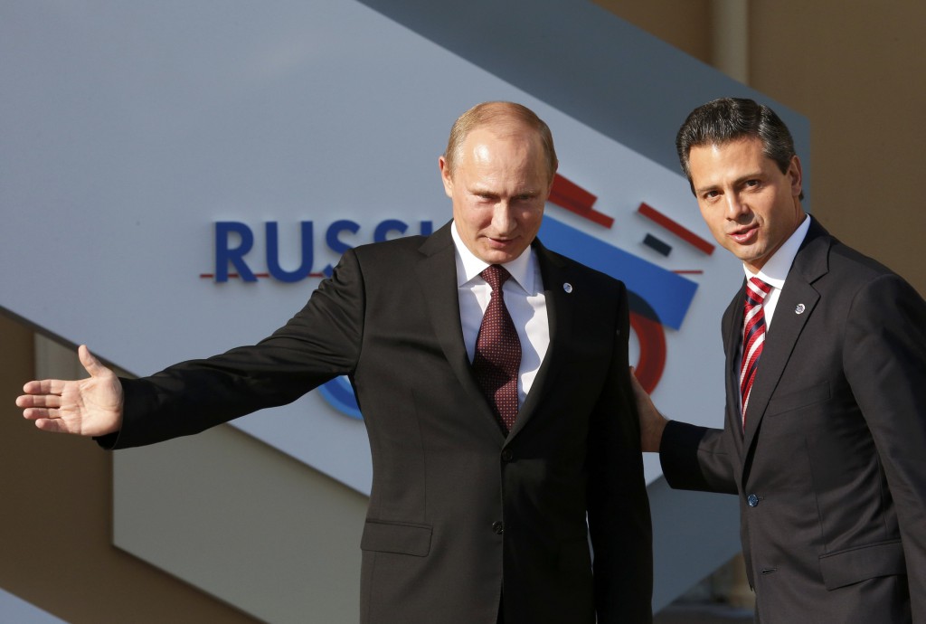 Russian President Vladimir Putin welcomes Mexican President Enrique Pena Nieto before the first working session of the G-20 Summit in St. Petersburg, Russia, Sept. 5. In a letter to Putin, Pope Francis wrote that, "from the very beginning of the conflict in Syria, one-sided interests have prevailed and in fact hindered the search for a solution that would have avoided the senseless massacre now unfolding." PHOTO: CNS/Grigory Dukor, Reuters