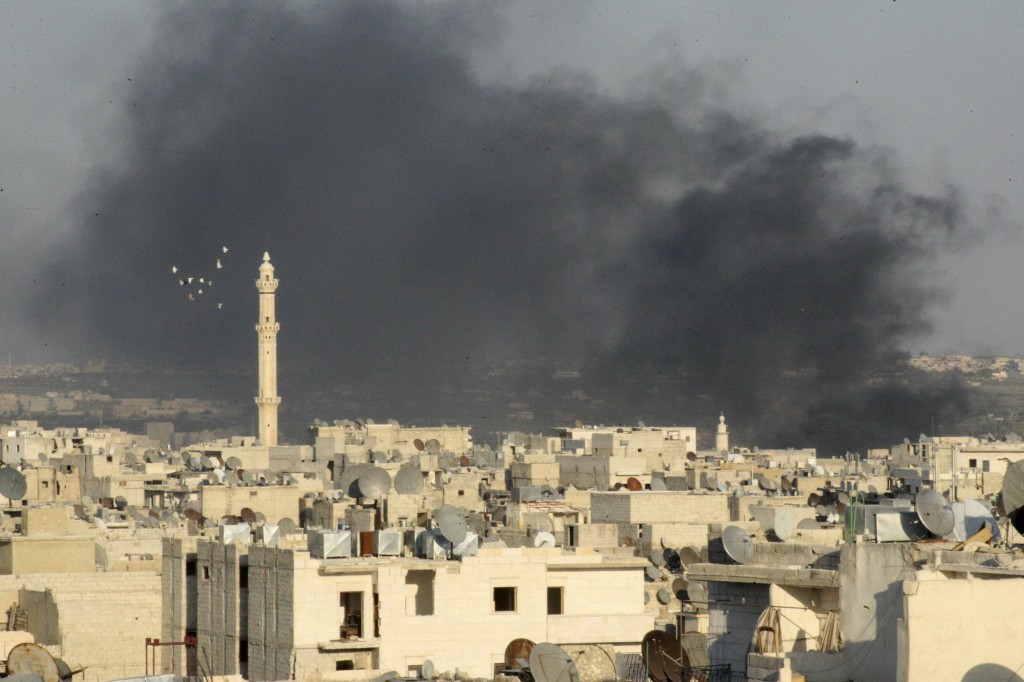 Smoke rises amid buildings in Aleppo, Syria, Sept. 4.  Christian leaders of the Holy Land gathered there Sept. 7, as Christians and Muslims all over the world prayed with Pope Francis for Syria. PHOTO: CNS/Ammar Abdulla, Reuters