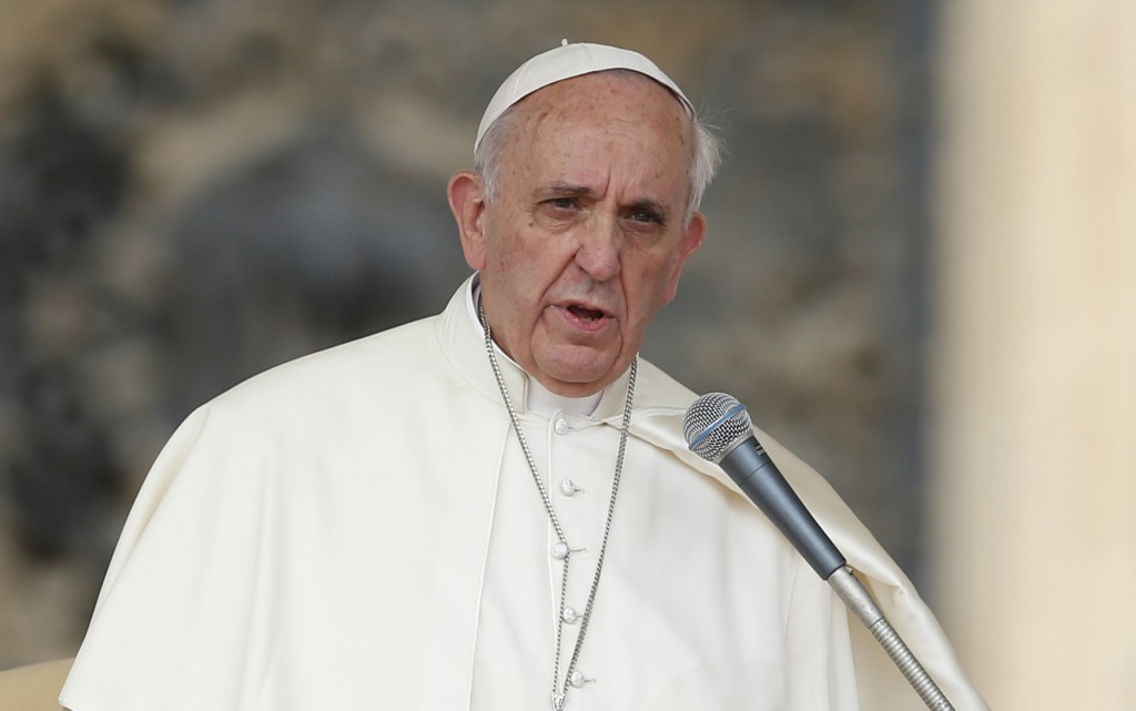 Pope Francis leads the crowd in prayer as he begins his general audience on Sept. 11 in St. Peter's Square at the Vatican. PHOTO: CNS/Paul Haring