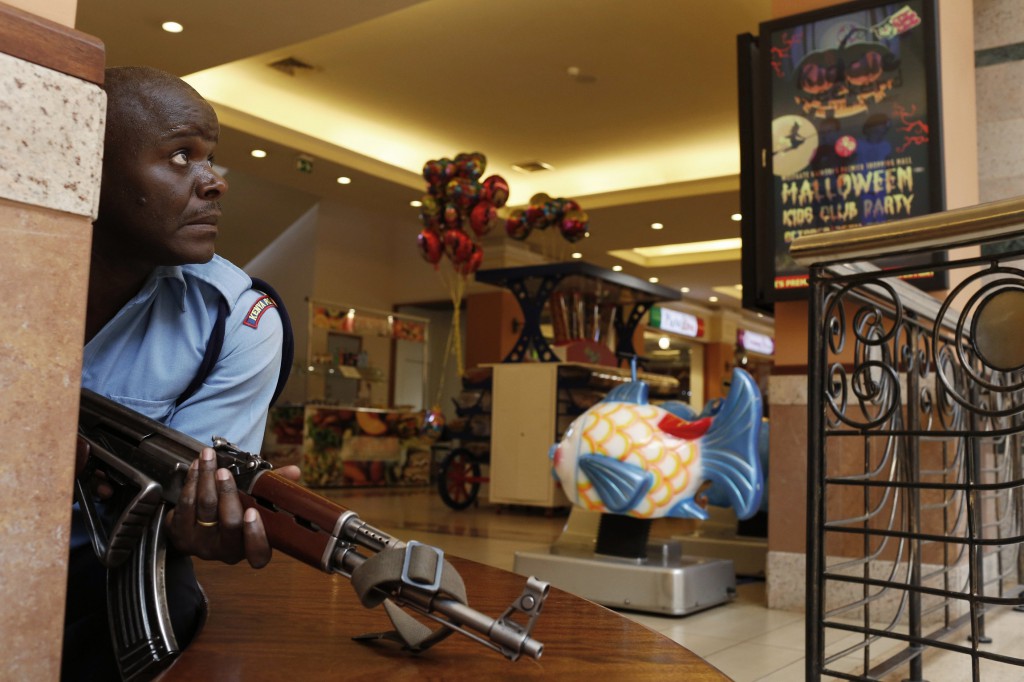 A police officer tries to secure an area inside the Westgate Shopping Center where gunmen went on a shooting spree in Nairobi, Kenya, Sept. 21. Kenya's military said Sept. 23 it had rescued most of the hostages being held captive by al-Qaida-linked militants during a standoff that killed dozens of people and injured at least 175. PHOTO: CNS/Siegfried Modola, Reuters