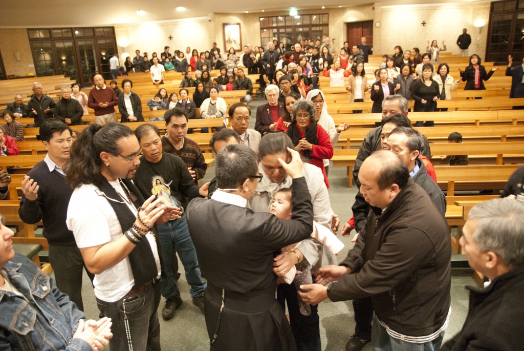 After preaching and leading the congregation during an evening service at Good Shepherd Parish in Lockridge, Fr Michael Nguyen, a Vietnamese-born Redemptorist based in Rome, prays over participants. Hundreds attended his talks in three parishes in Perth and came forward to receive prayers for a myriad of intentions. PHOTO: Robert Hiini