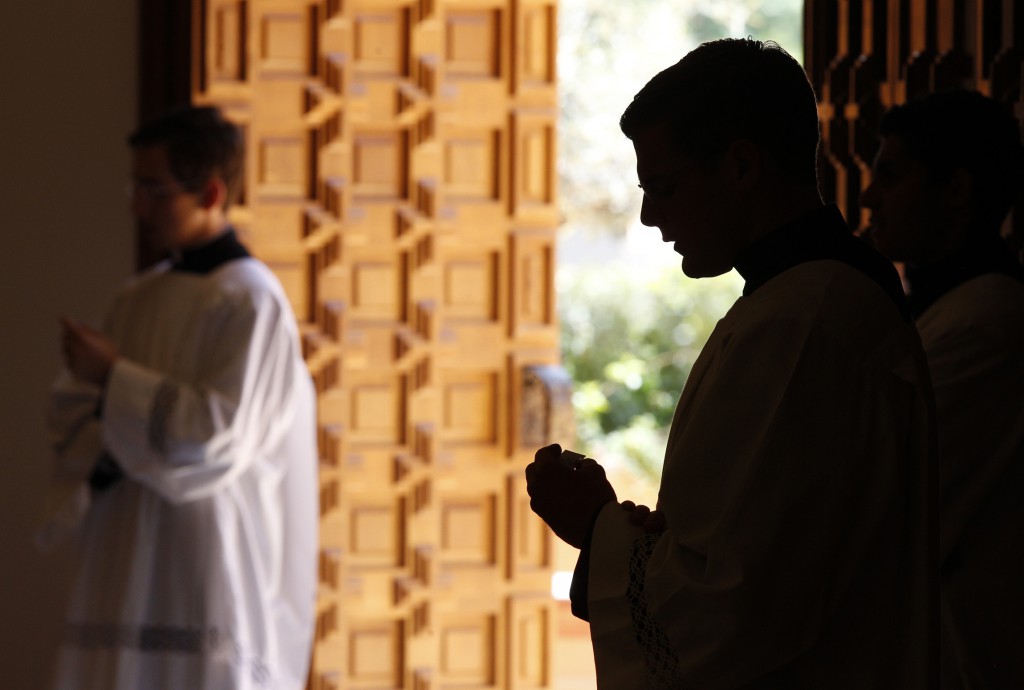 A Legionaries of Christ seminarian is silhouetted as he attends a Mass on June 7 with members of Regnum Christi in the chapel of Regina Apostolorum University in Rome. 