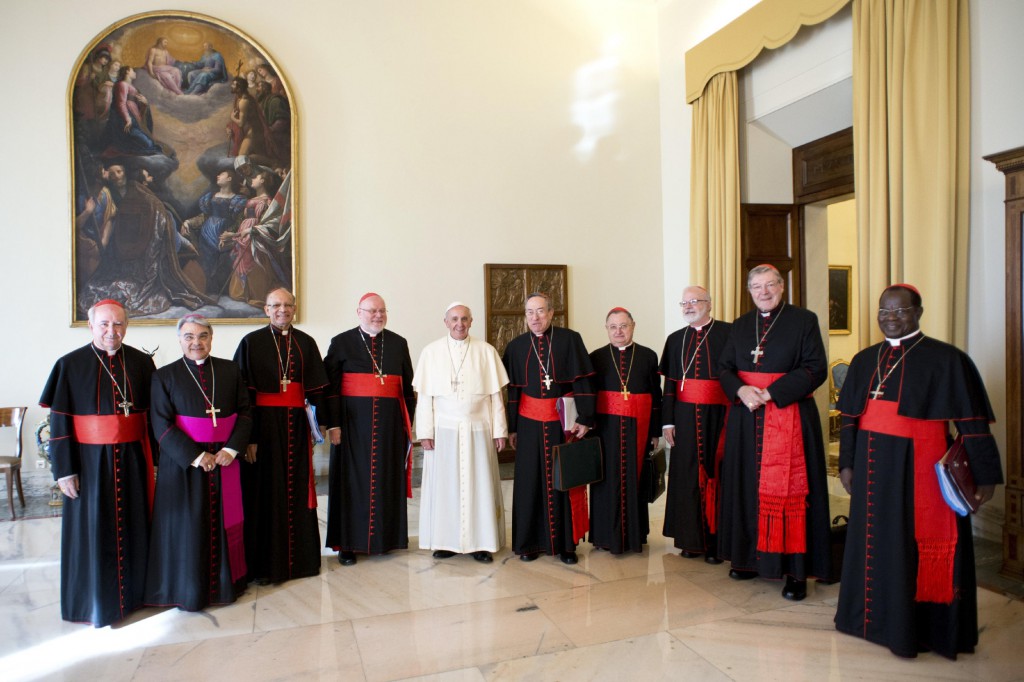 Pope Francis poses with cardinal advisers during a meeting at the Vatican Oct. 1. Eight cardinals began closed-door meetings with the pope Oct. 1 to help him reform the Roman Curia and study possible changes in the worldwide Church. Pictured from left are: Chilean Cardinal Francisco Javier Errazuriz Ossa, Italian Bishop Marcello Semeraro, secretary to the Council of Cardinals, Indian Cardinal Oswald Gracias, German Cardinal Reinhard Marx, Pope Francis, Honduran Cardinal Oscar Rodriguez Maradiaga, Italian Cardinal Giuseppe Bertello, U.S. Cardinal Sean P. O'Malley, Australian Cardinal George Pell and Congolese Cardinal Laurent Monsengwo Pasinya. PHOTO: CNS/L'Osservatore Romano via Reuters