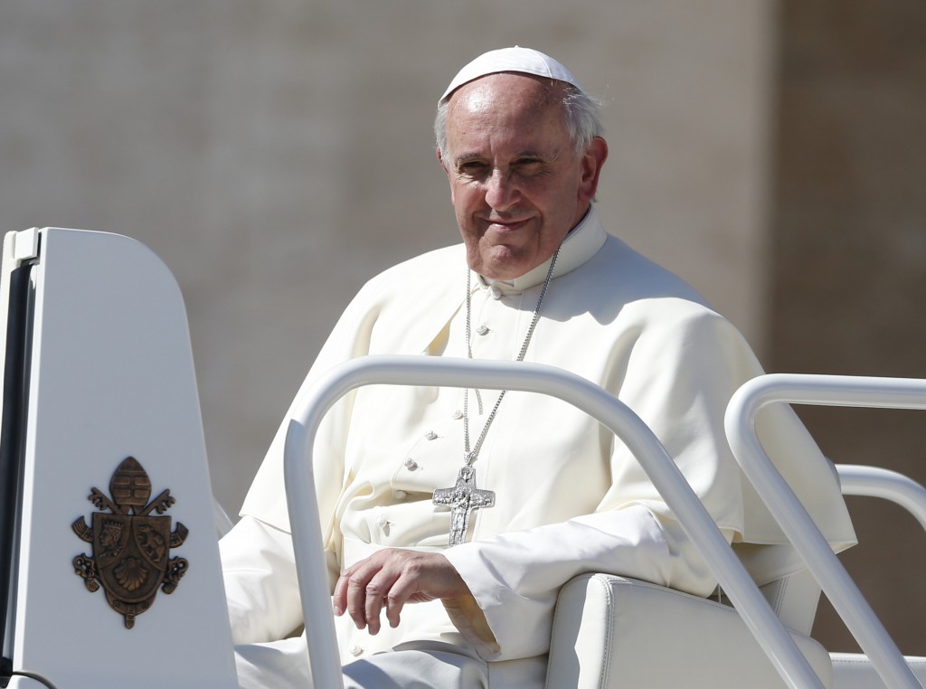 Pope Francis leaves his general audience in St. Peter's Square at the Vatican Oct. 2. The logo on the popemobile is that of Pope Benedict XVI. PHOTO: CNS/Paul Haring