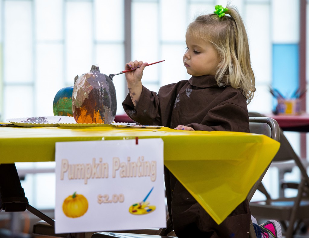 Rosalyn Paye, 2, paints a pumpkin during a fall festival on Oct. 27 at St. John Bosco School in Sturgeon Bay, Wis. PHOTO: CNS/Sam Lucero, The Compass