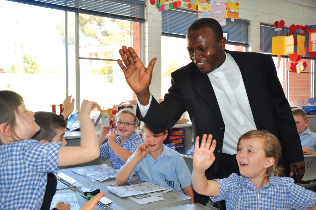 Fr Emmanuel shows he’s a hit with the local primary school students. PHOTO: Michael Shepherd