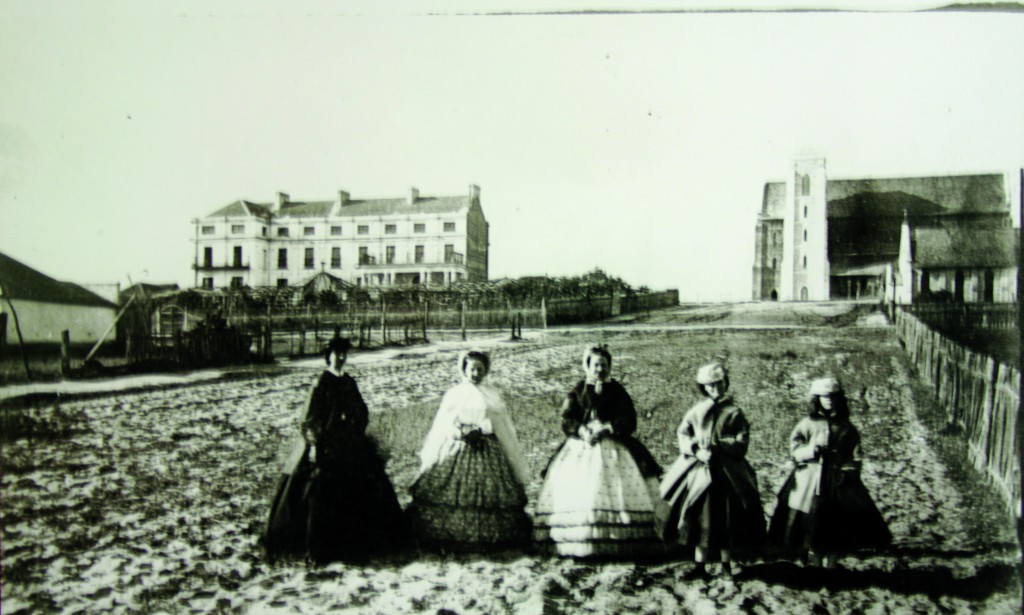 A photograph taken by AH Stone in 1868 shows five prominent Perth ladies out for a stroll. They are the Governess, Maria Stone, left; Maria’s sister, Miss Helms and friends of the family. The photograph is taken in Victoria Avenue, Perth. In the background are the Bishop’s palace, completed in 1856 on the left, and the Cathedral of the Immaculate Conception of the Blessed VIrgin Mary, completed in 1865. Directly in front of the cathedral is the smaller St John’s Church, the first Catholic church in WA. PHOTO: Courtesy of Mrs Dorothy Croft