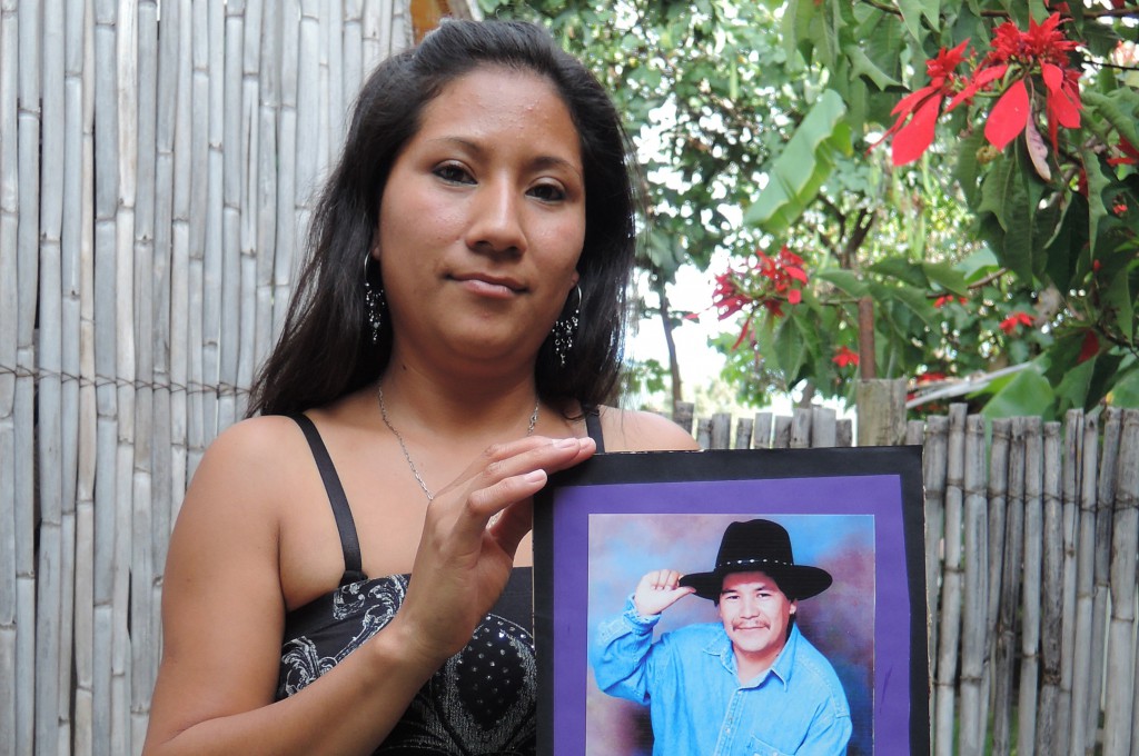 Ana Lilia Vazquez holds a photo of her late father, Anselmo Vazquez, outside her home in Malinalco, Mexico, Oct. 30. Vazquez placed the photo on a Day of the Dead altar built by the families of migrants whose loved ones died while in the United States or shortly after returning to Mexico.  PHOTO: CNS/David Agren