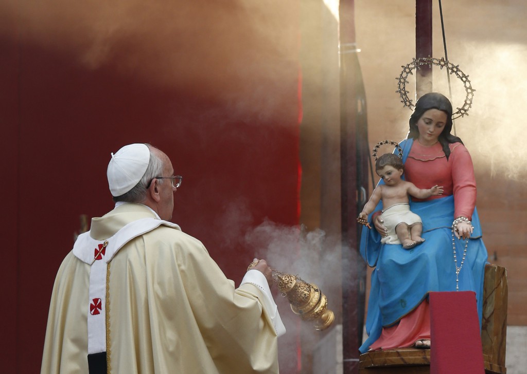 Pope Francis uses incense to venerate a statue of Mary as he celebrates Mass at the Verano cemetery in Rome Nov. 1, the feast of All Saints. PHOTO: CNS/Paul Haring