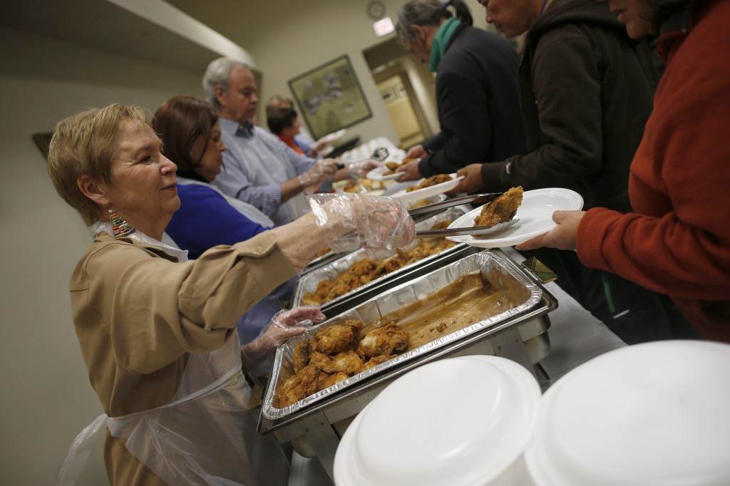 Volunteers serve people during a free dinner provided Nov. 1 by the Emergency Assistance Department of Chicago Catholic Charities. Archbishop Francis A. Chullikatt, Vatican nuncio to the United Nations, told world leaders Oct. 29 they must share one goal of food security so fewer and fewer people around the world will suffer from poverty and hunger. PHOTO: CNS/Jim Young, Reuters
