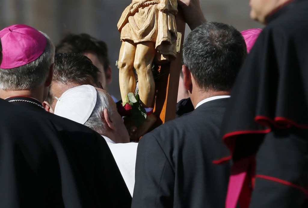 Pope Francis kisses a crucifix during his general audience in St. Peter's Square on Nov. 6 at the Vatican. PHOTO: 
