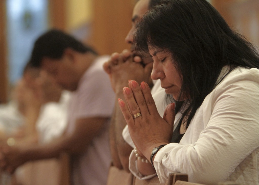 People pray during a Spanish-language Mass at St. John the Evangelist Church in Riverhead, N.Y., in August. During their annual fall assembly, the U.S. bishops approved several steps toward adapting the Mexican Misal Romano for use in the U.S. PHOTO: CNS/Gregory A. Shemitz, Long Island Catholic