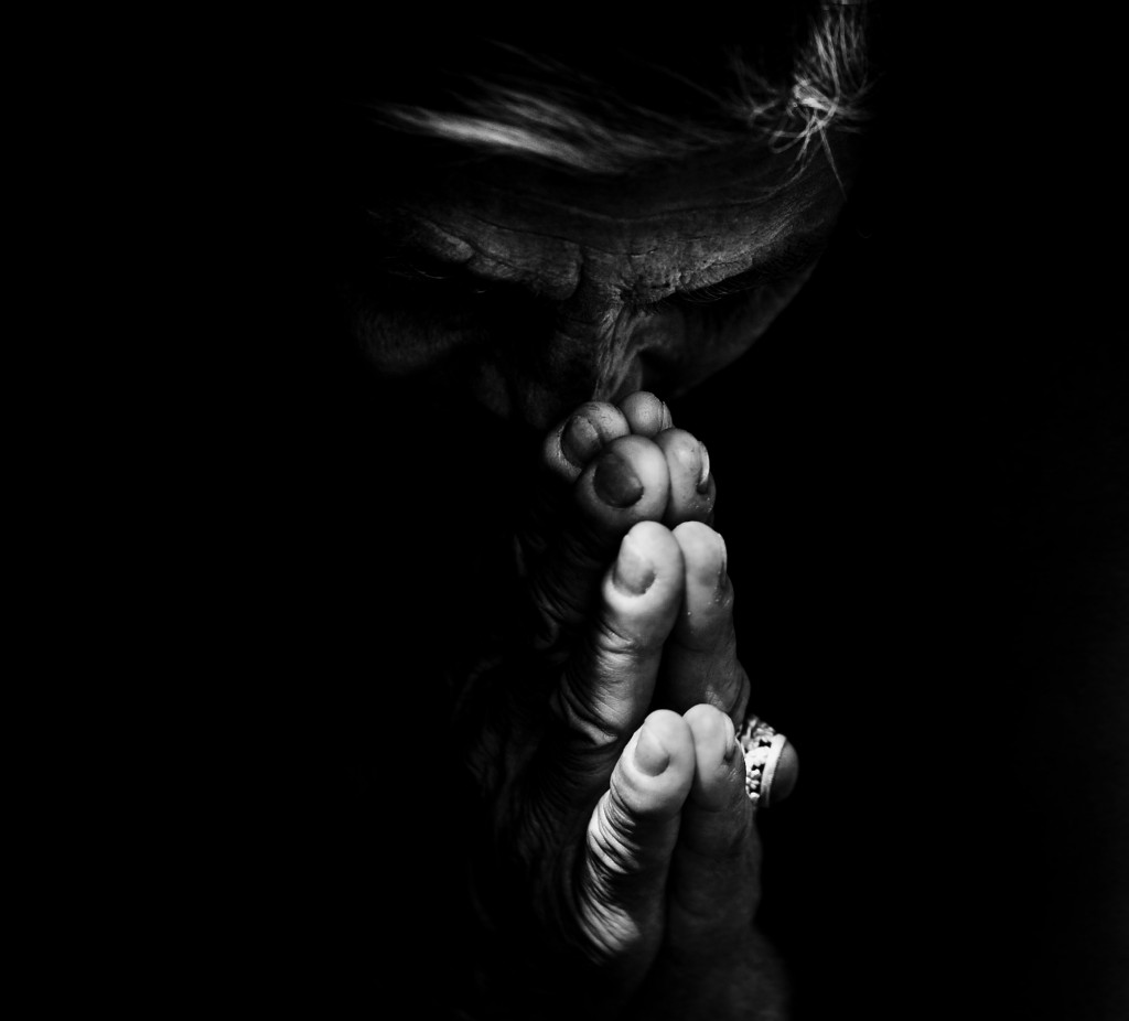 This image of a homeless woman with praying hands in Rome is part of an exhibition by Lee Jeffries at the Museum of Rome.