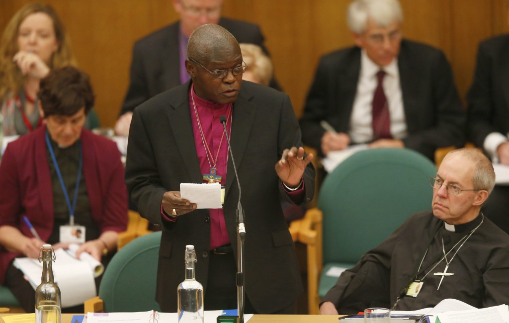 Anglican Archbishop John Sentamu of New York speaks as Archbishop Justin Welby of Canterbury, the leader of the worldwide Anglican Communion looks on during the Church of England's General Synod at Church House in central London Nov. 20. The Church of England's law-making body voted in favor of female bishops that day, a move that ended a 20-year impasse and could see women ordained as senior clergy by the end of 2014. PHOTO: CNS/Andrew Winning, Reuters
