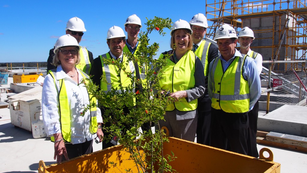ministers, hospital executives, and construction leaders celebrate a recent building milestone with a traditional construction ‘topping out’ ceremony. PHOTO: SJOG