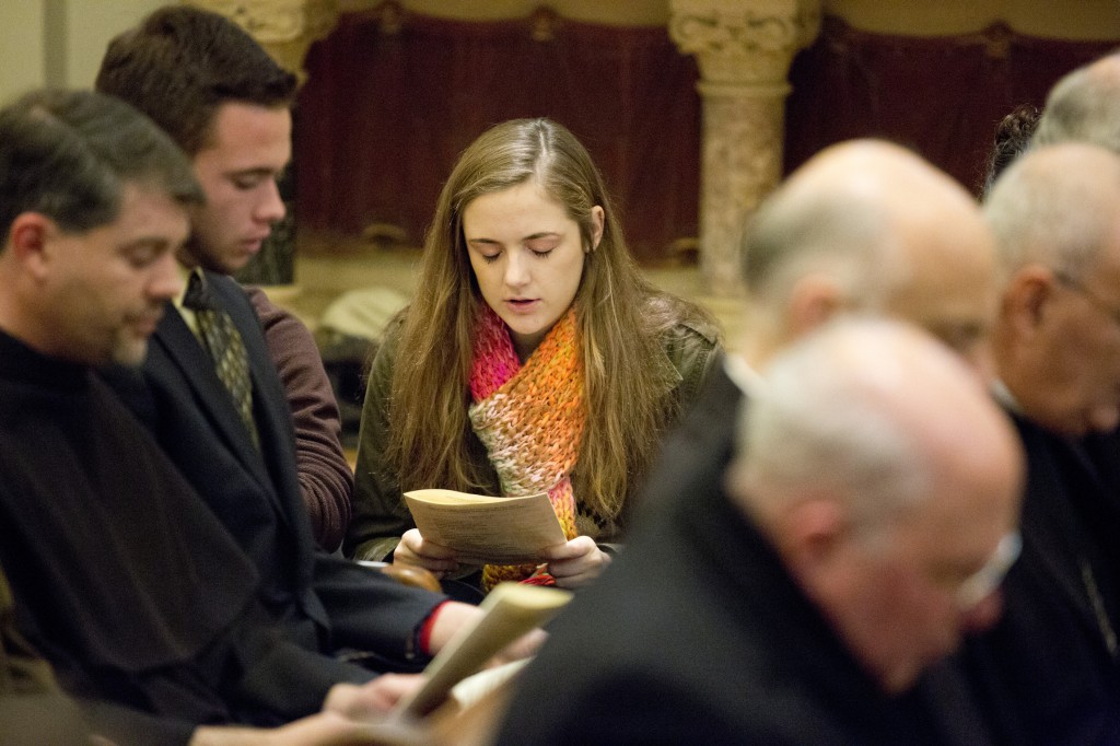 A young woman prays next to students and clergymen during a Dec. 10 prayer service to end world hunger at Caldwell Chapel on the campus of The Catholic University of America in Washington. According to Caritas Internationalis, the Vatican-based federation of Catholic charities, about one in eight people experienced chronic hunger or undernourishment during 2010-2012. PHOTO:CNS/Tyler Orsburn
