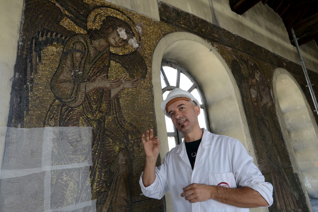 Marcello Piacenti of Italy, project manager on the renovation of the roof of the Church of the Nativity, gestures as he stands in front of a mosaic from 1,100 A.D., the Crusader period, in the West Bank town of Bethlehem Nov. 20. More than five years in the planning and researching, the restoration of the church's wooden beams and lead roof and its 38 windows represents the beginning of an ambitious project. PHOTO: CNS/Debbie Hill
