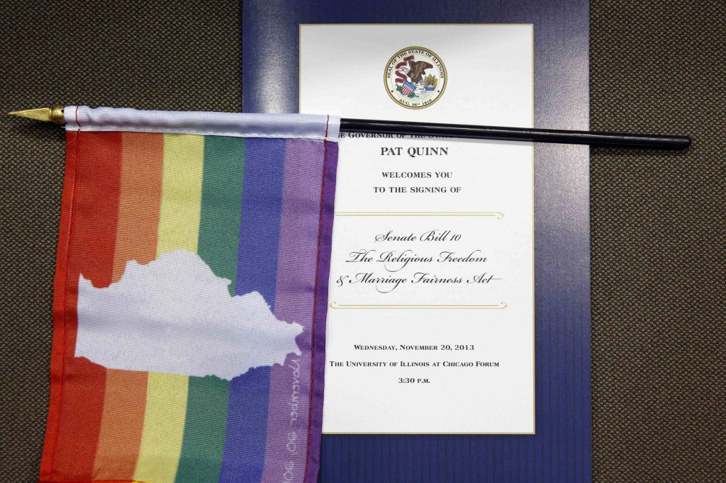 A flag is seen overlaying a program for a ceremony in late November to mark the signing of Illinois Marriage Equality Legislation in Chicago. As 2013 came to a close, New Mexico became the latest state to legalize same-sex marriage. Court cases on marriage are on the horizon in Michigan and Nevada for 2014. PHOTO: CNS/Jim Young, Reuters