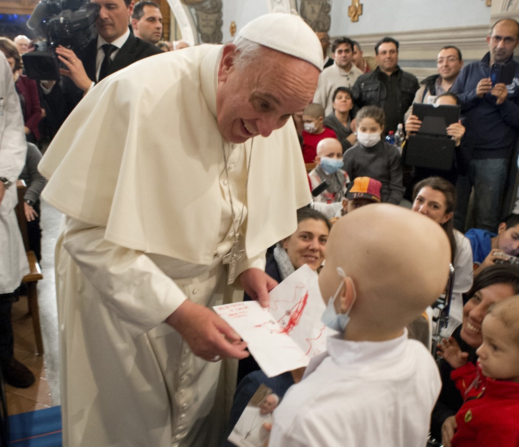 Pope Francis receives a letter from a child during a visit to the Bambino Gesu children's hospital on  Dec. 21 in Rome. PHOTO: CNS/L'Osservatore Romano via Reuters