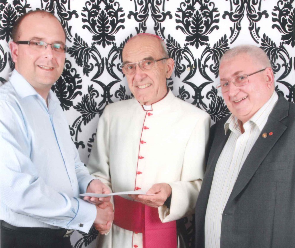 The Knights’ George Sekulla, left, and Peter Lewis, right, with the Bishop of Geraldton, Justin Bianchini.