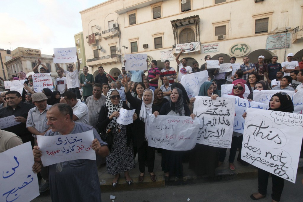 Demonstrators hold signs during a rally Sept. 12 in Benghazi, Libya, to condemn the killers of J. Christopher Stevens, U.S. ambassador to Libya, and the attack on the U.S. consulate in the city. CNS/Esam Al-Fetori, Reuters