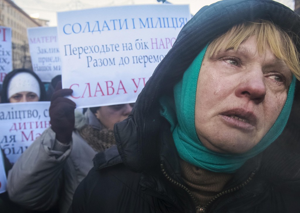 A woman cries as she and others appeal to Ukrainian police troops at the site of clashes with protesters in Kiev Jan. 24. Since mid-January  violent clashes have escalated between police and the demonstrators, who had gathered peacefully urging stronger ties with Western Europe. PHOTO: CNS/Gleb Garanich, Reuters