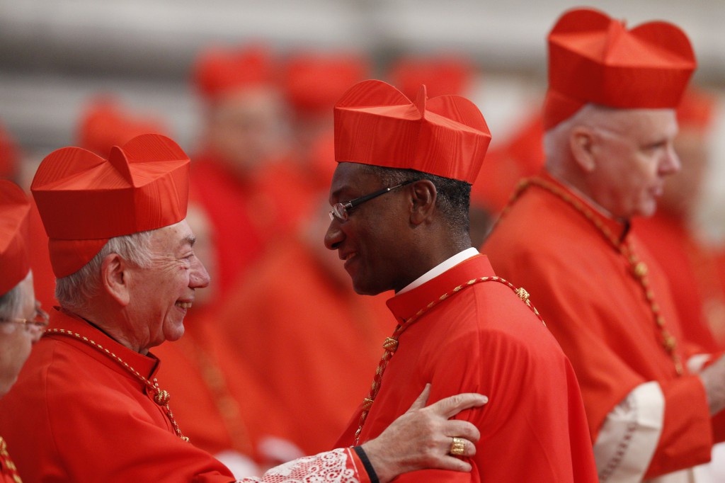 Italian Cardinal Francesco Coccopalmerio greets new Cardinal Chibly Langlois of Les Cayes, Haiti, during a consistory at which Pope Francis created 19 new cardinals on Feb. 22 in St. Peter's Basilica at the Vatican. PHOTO: CNS/Paul Haring