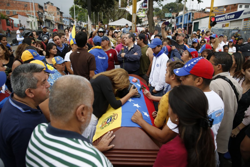 Carmen Gonzalez mourns over the coffin of her son, Jimmy Vargas, during his Feb. 26 funeral in San Cristobal, Venezuela. Vargas died during anti-government protests. Pope Francis called for an immediate end to violence in Venezuela and urged politicians to take the lead in calming the nation's worst unrest for a decade. PHOTO: CNS/Carlos Garcia, Reuters