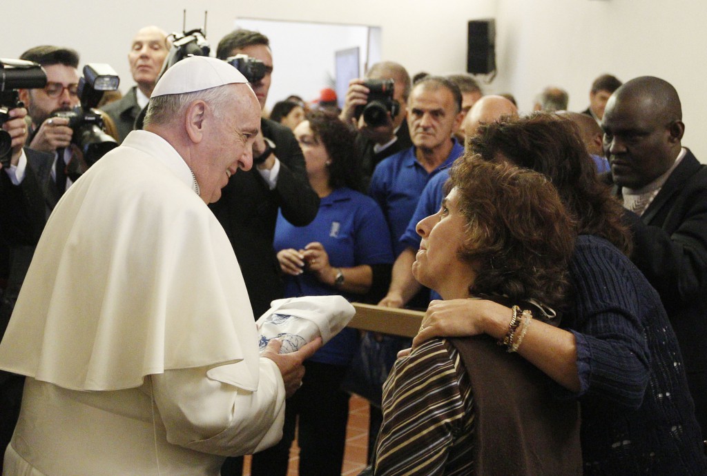 Pope Francis meets with the poor in 2013 at the archbishop's residence in Assisi, Italy. Pope Francis' most frequent advice and exhortation to Catholics: "Go forth." PHOTO: CNS/Paul Haring