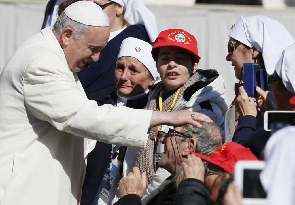 Pope Francis blesses a man in a wheelchair as he greets the sick and disabled during his general audience on March 5 in St. Peter's Square at the Vatican. PHOTO: CNS/Paul Haring