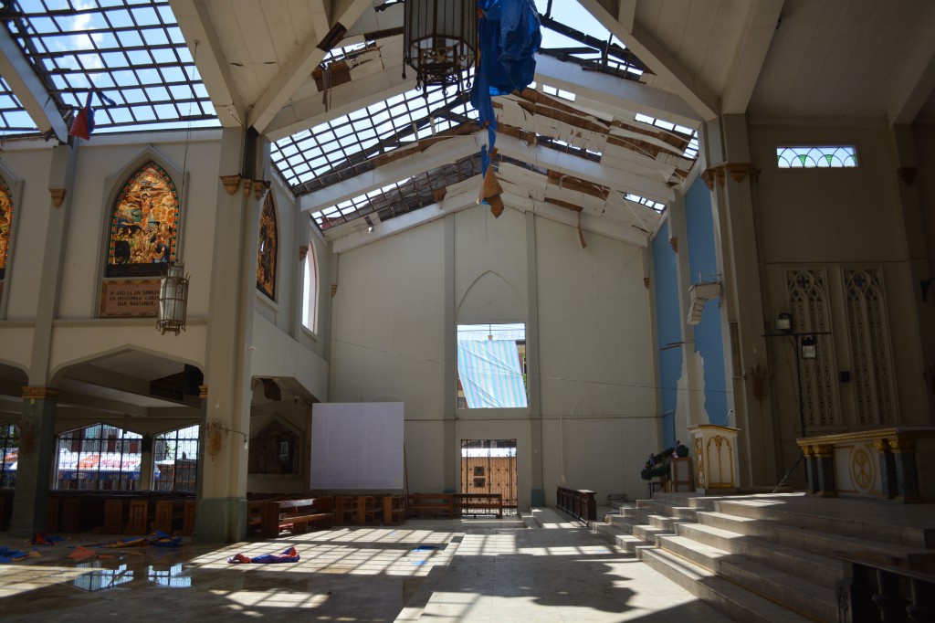 Sunlight shines through the partially roofless Santo Nino Church March 9 in Tacloban, four months after Typhoon Haiyan swept across the central Philippines. The church is under rehabilitation thanks to a donation of about $280,000 from a Taiwan-based Buddhist foundation called Tzu Chi. PHOT: CNS/Simone Orendain