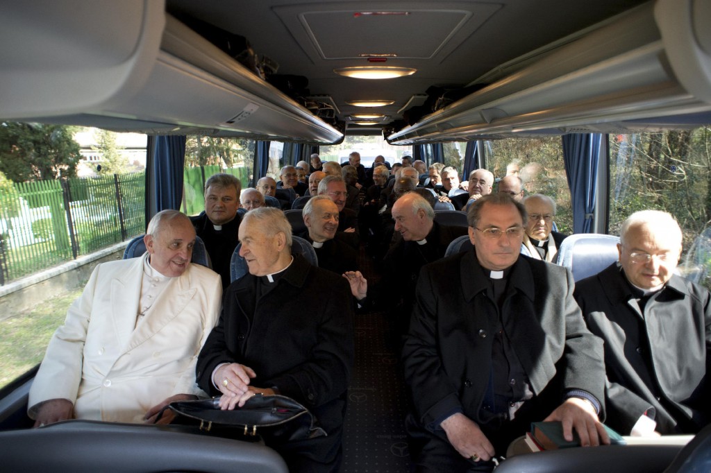 Pope Francis rides in a bus with cardinals and bishops at the and of their weeklong Lenten retreat in Ariccia, Italy, March 14. At the end of the retreat, Pope Francis said he and his closest collaborators at the Vatican "want to follow Jesus more closely, without losing hope in his promises and without losing a sense of humor." PHOTO: CNS/L'Osservatore Romano via Reuters