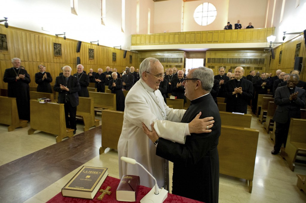 Pope Francis greets a clergyman at the and of his weeklong Lenten retreat in Ariccia, Italy, March 14. At the end of his retreat, Pope Francis said he and his closest collaborators at the Vatican "want to follow Jesus more closely, without losing hope in his promises and without losing a sense of humor." PHOTO: CNS